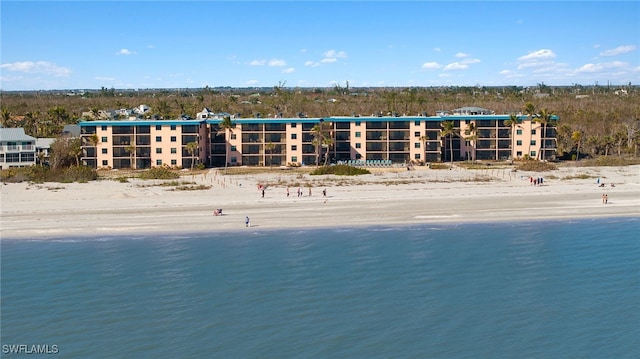 birds eye view of property with a water view and a view of the beach