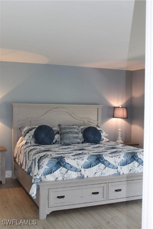 bedroom with light wood finished floors