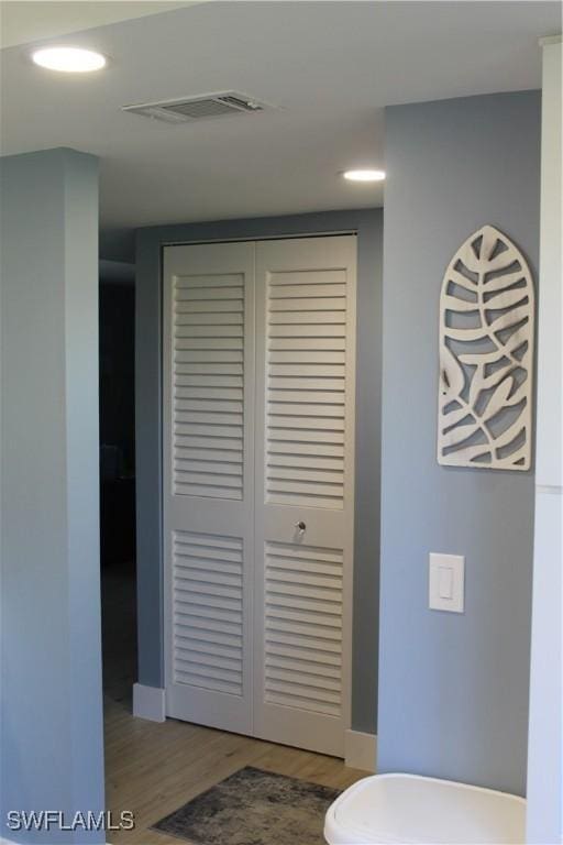 interior space with visible vents, baseboards, and wood finished floors