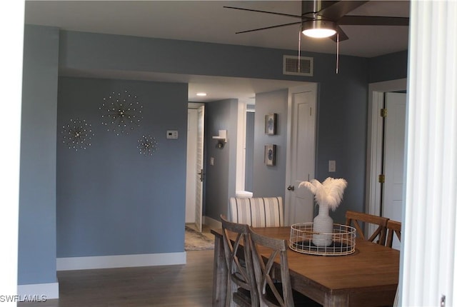 dining area featuring a ceiling fan, baseboards, visible vents, and wood finished floors