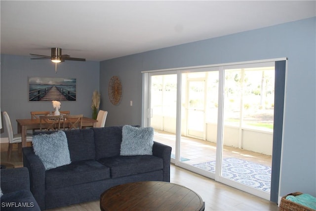 living room with light wood finished floors and a ceiling fan