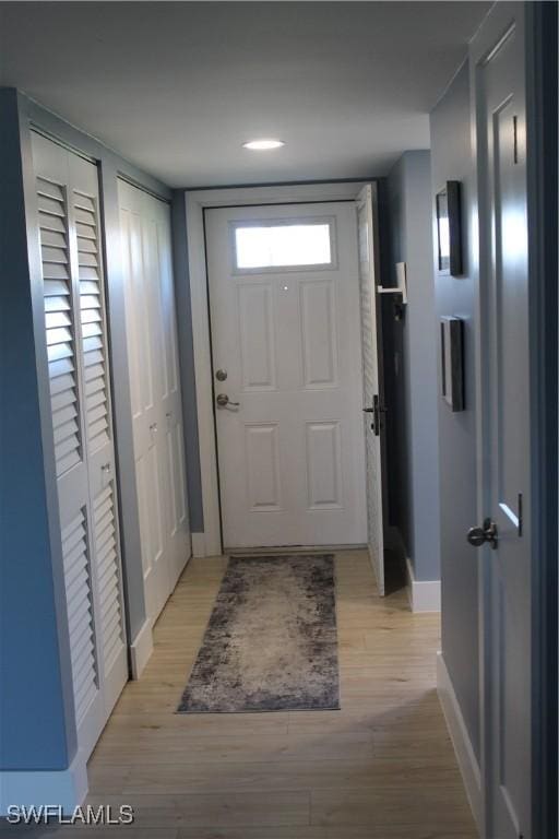 entryway featuring light wood-type flooring and baseboards