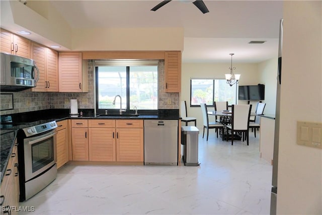 kitchen with marble finish floor, stainless steel appliances, visible vents, decorative backsplash, and a sink