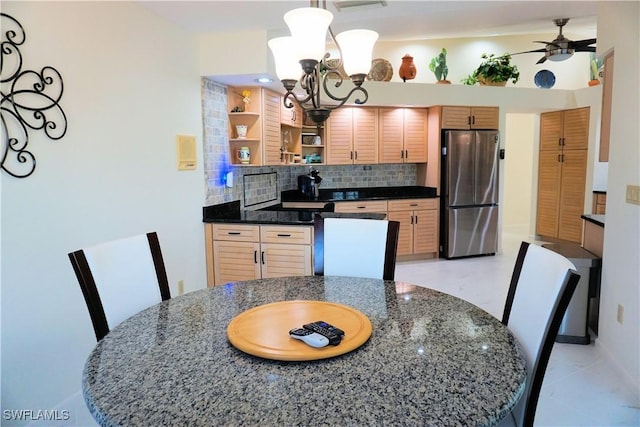 kitchen featuring decorative light fixtures, open shelves, tasteful backsplash, freestanding refrigerator, and ceiling fan with notable chandelier