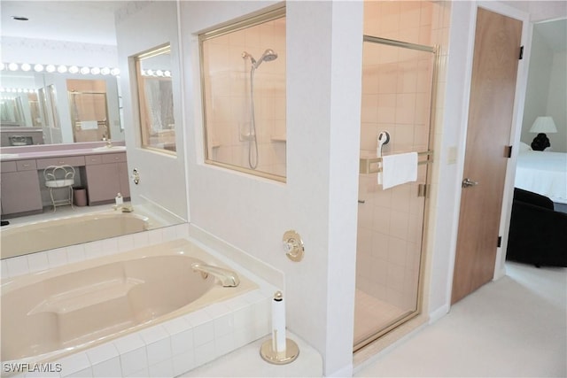 ensuite bathroom featuring a stall shower, ensuite bath, and a garden tub