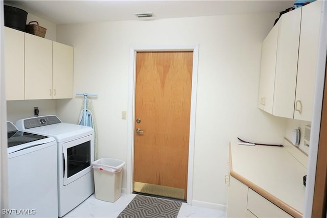 clothes washing area with cabinet space, baseboards, visible vents, and washer and clothes dryer