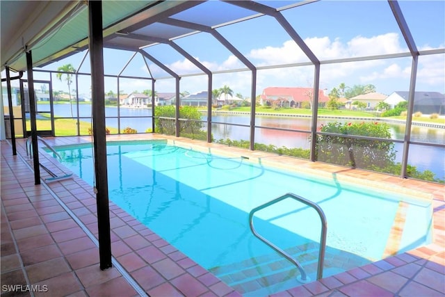 outdoor pool with glass enclosure, a patio, a water view, and a residential view