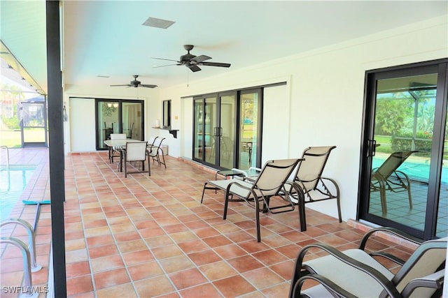 view of patio with a ceiling fan, outdoor dining space, glass enclosure, and an outdoor pool