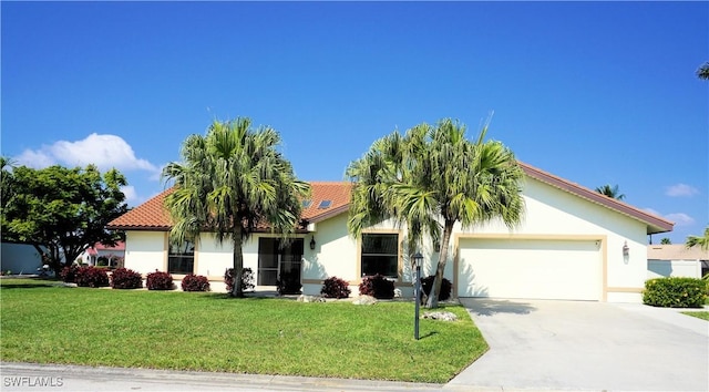 view of front facade with an attached garage, concrete driveway, a front yard, and stucco siding