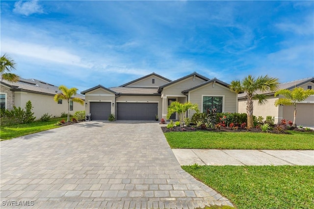 single story home featuring decorative driveway, an attached garage, stucco siding, and a front yard