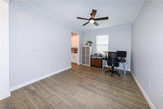 office space featuring baseboards, a ceiling fan, and wood finished floors