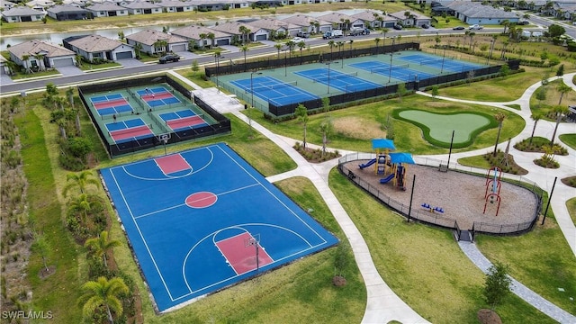 view of basketball court featuring fence, a residential view, and community basketball court