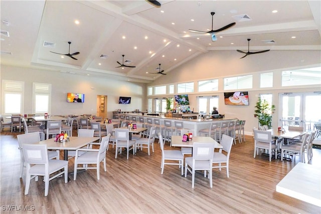 dining room with beamed ceiling, plenty of natural light, ceiling fan, and high vaulted ceiling