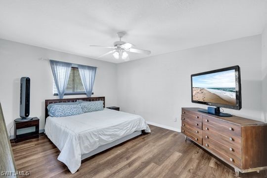 bedroom featuring dark wood-type flooring and ceiling fan