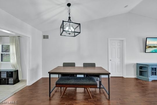 dining space featuring lofted ceiling and dark wood-type flooring