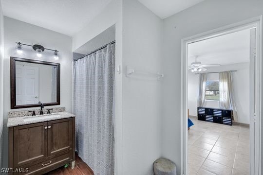 bathroom featuring vanity, tile patterned floors, and ceiling fan