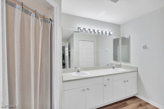 bathroom featuring vanity and hardwood / wood-style floors