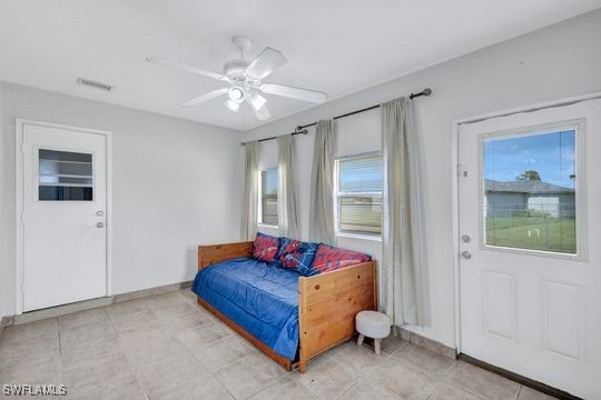 bedroom with multiple windows and ceiling fan