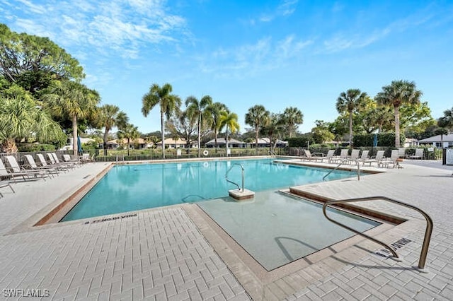 pool featuring a patio and fence