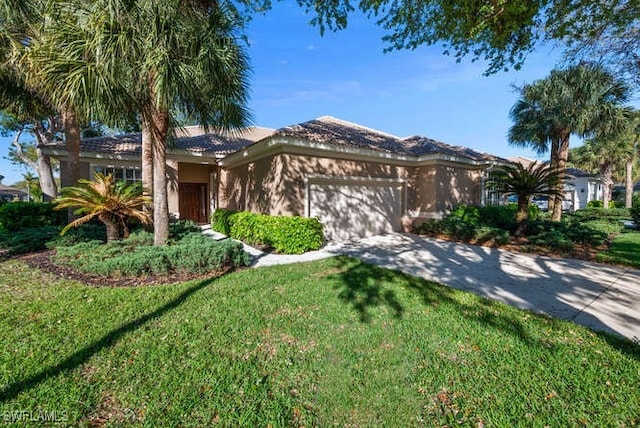 view of front of home featuring concrete driveway, a garage, a front yard, and stucco siding