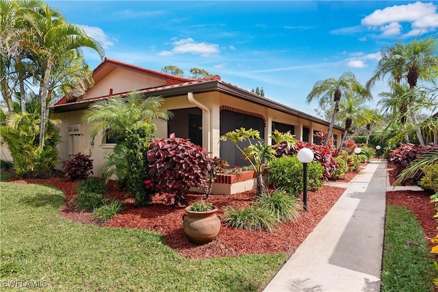 view of home's exterior featuring a yard and stucco siding