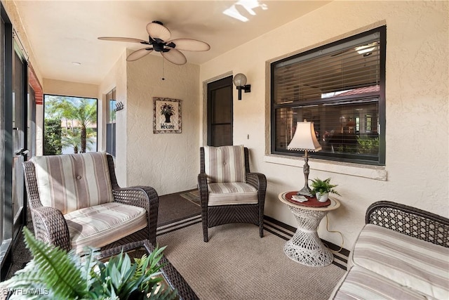 sunroom featuring a ceiling fan