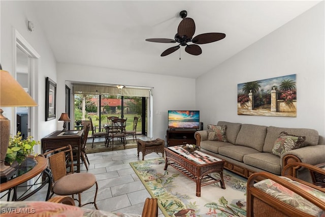 living room featuring light tile patterned floors, a ceiling fan, and vaulted ceiling