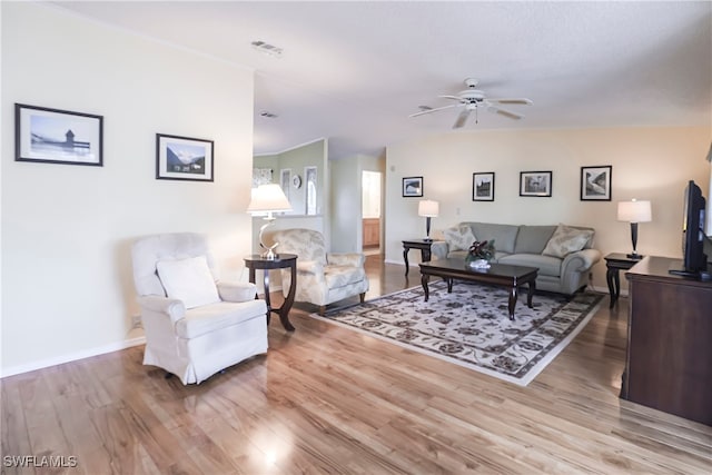 living room featuring hardwood / wood-style flooring and ceiling fan