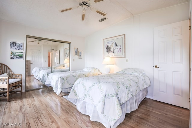 bedroom with hardwood / wood-style floors, ceiling fan, and a closet