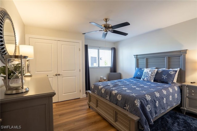 bedroom featuring a closet, dark wood finished floors, and a ceiling fan