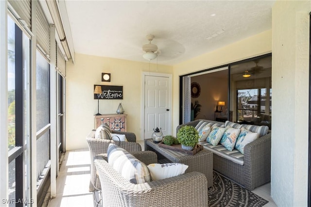 sunroom / solarium with a ceiling fan