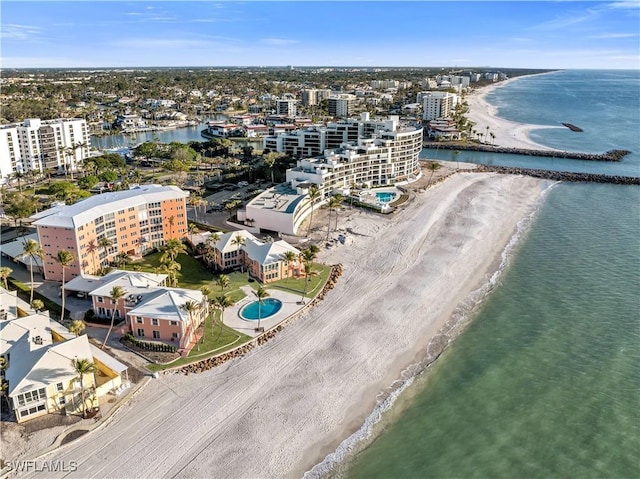 birds eye view of property featuring a beach view and a water view