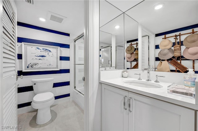 full bathroom featuring toilet, vanity, and bath / shower combo with glass door