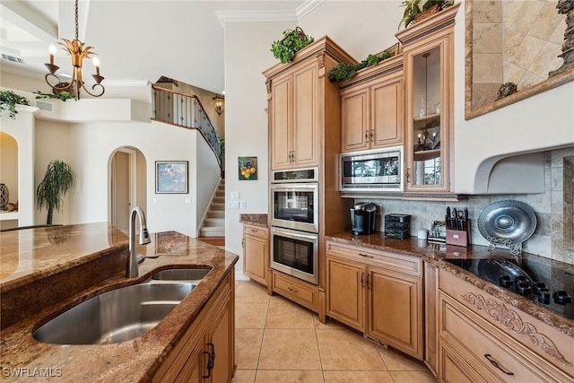 kitchen featuring stainless steel appliances, decorative light fixtures, sink, backsplash, and crown molding