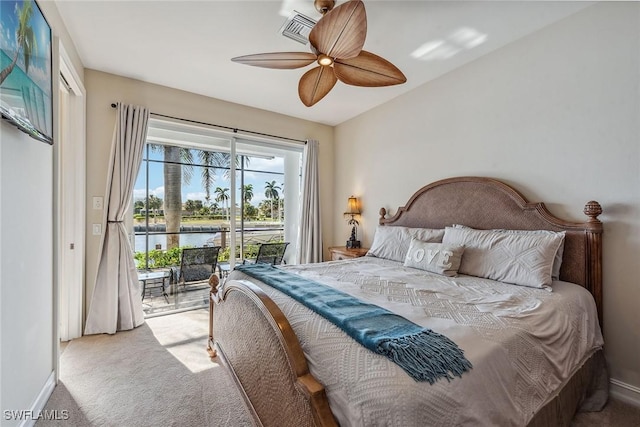 bedroom featuring access to outside, carpet floors, a water view, and ceiling fan