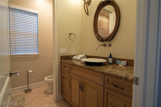 bathroom featuring vanity, toilet, and tile patterned floors