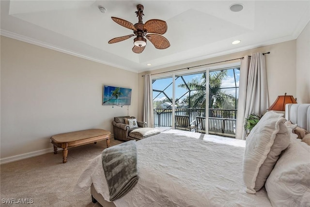 bedroom with a tray ceiling, access to outside, light colored carpet, and ornamental molding