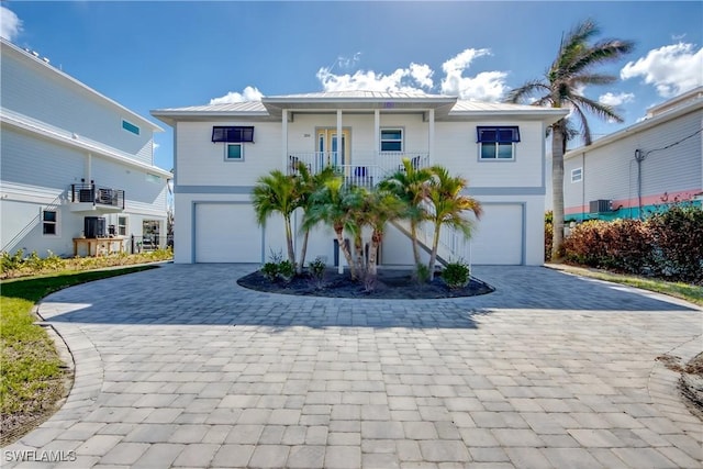 view of front of house featuring a garage and central air condition unit