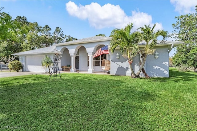 view of front of home with driveway, an attached garage, a front lawn, and stucco siding