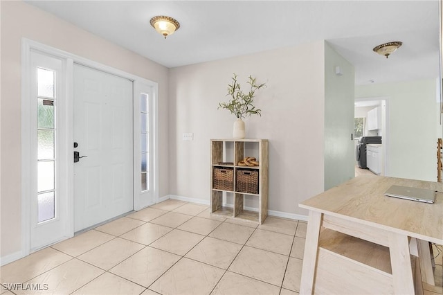 entryway with light tile patterned floors and baseboards