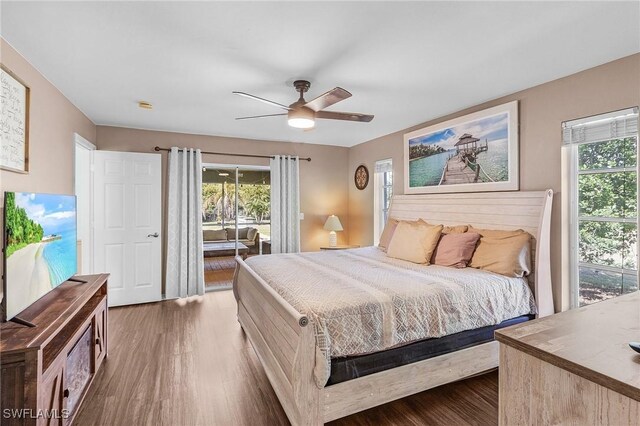 bedroom with ceiling fan, wood finished floors, and access to exterior