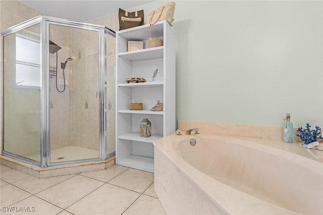 bathroom featuring tile patterned floors, a shower stall, and a bath