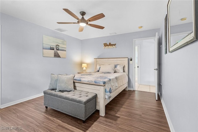 bedroom featuring wood finished floors, visible vents, and baseboards