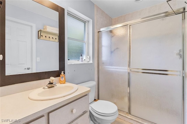 full bathroom with toilet, a shower stall, and vanity