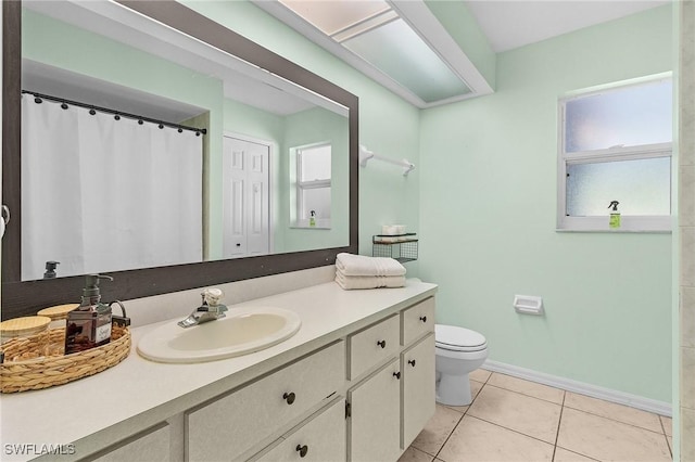 bathroom featuring baseboards, toilet, curtained shower, tile patterned flooring, and vanity