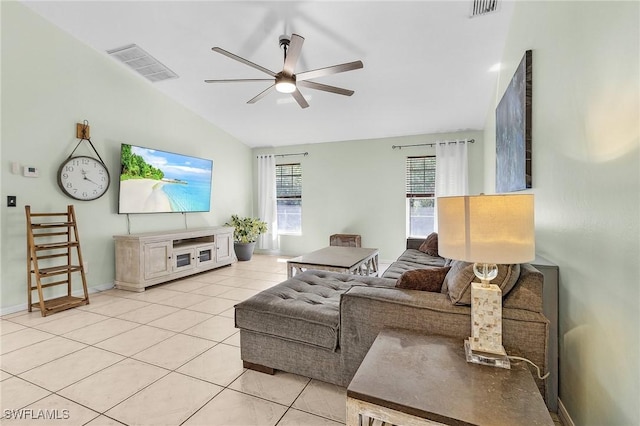 living room featuring lofted ceiling, light tile patterned flooring, visible vents, and a ceiling fan