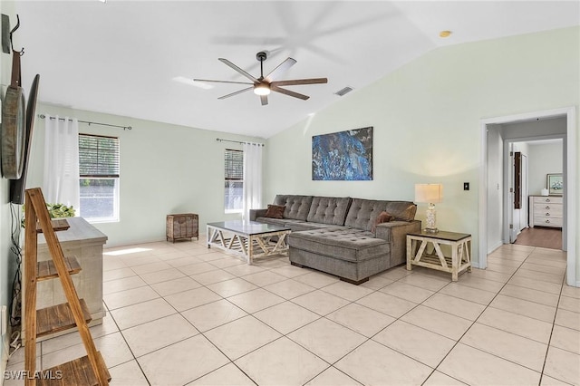 living room with lofted ceiling, light tile patterned flooring, visible vents, and a ceiling fan