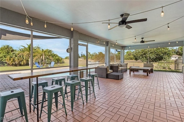 sunroom / solarium featuring track lighting