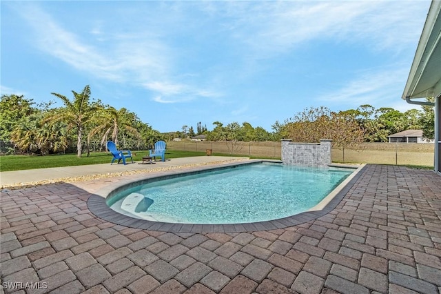 view of swimming pool featuring a lawn, a patio area, fence, and a fenced in pool