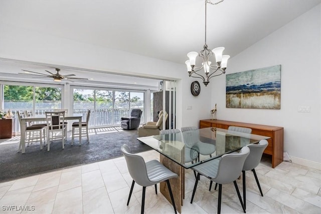 dining room featuring lofted ceiling, baseboards, and ceiling fan with notable chandelier